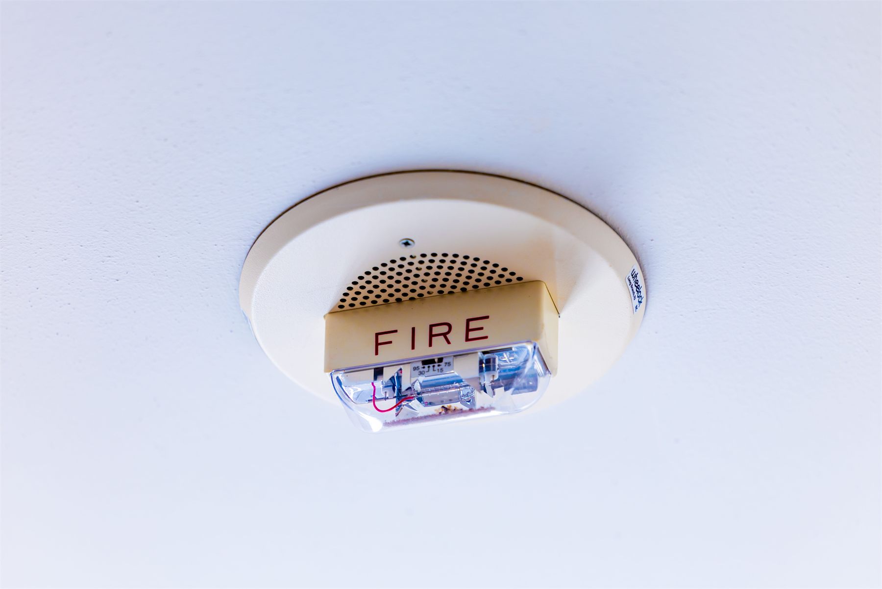 Ceiling-mounted fire alarm sounder and detector in a residential property